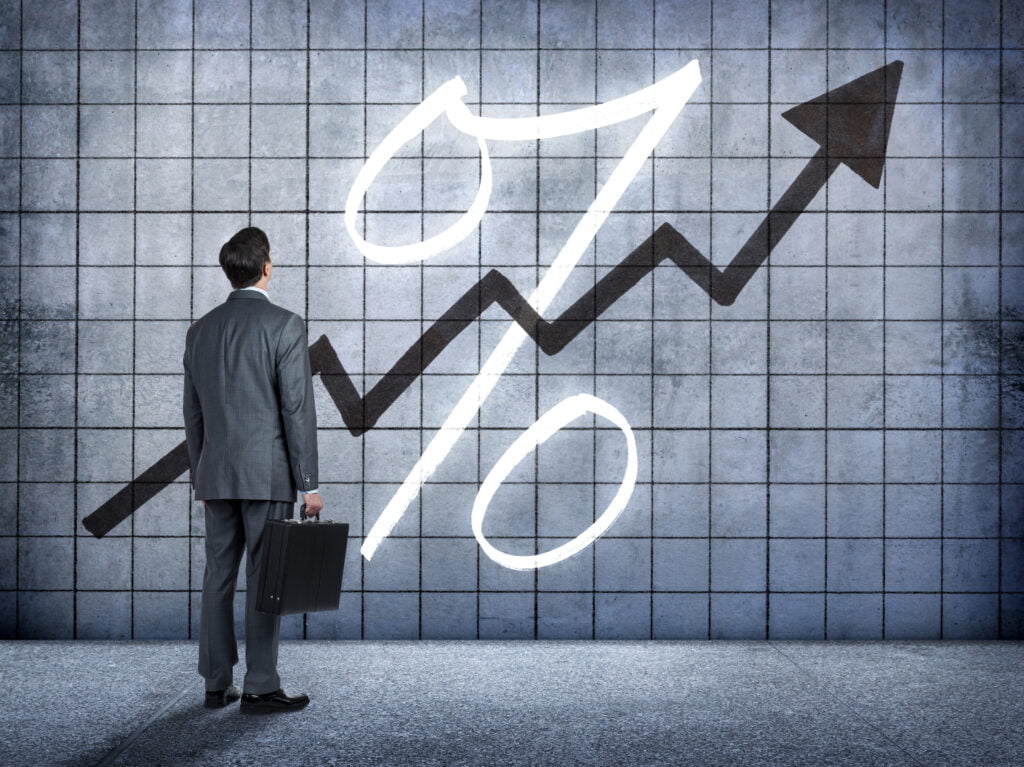 Businessman Looking At Prospect Of Higher Interest Rates ขึ้นดอกเบี้ย