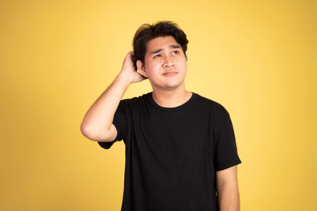 unsure asian young man wearing black shirt คิดแค่พรุ่งนี้จะกินอะไรดี