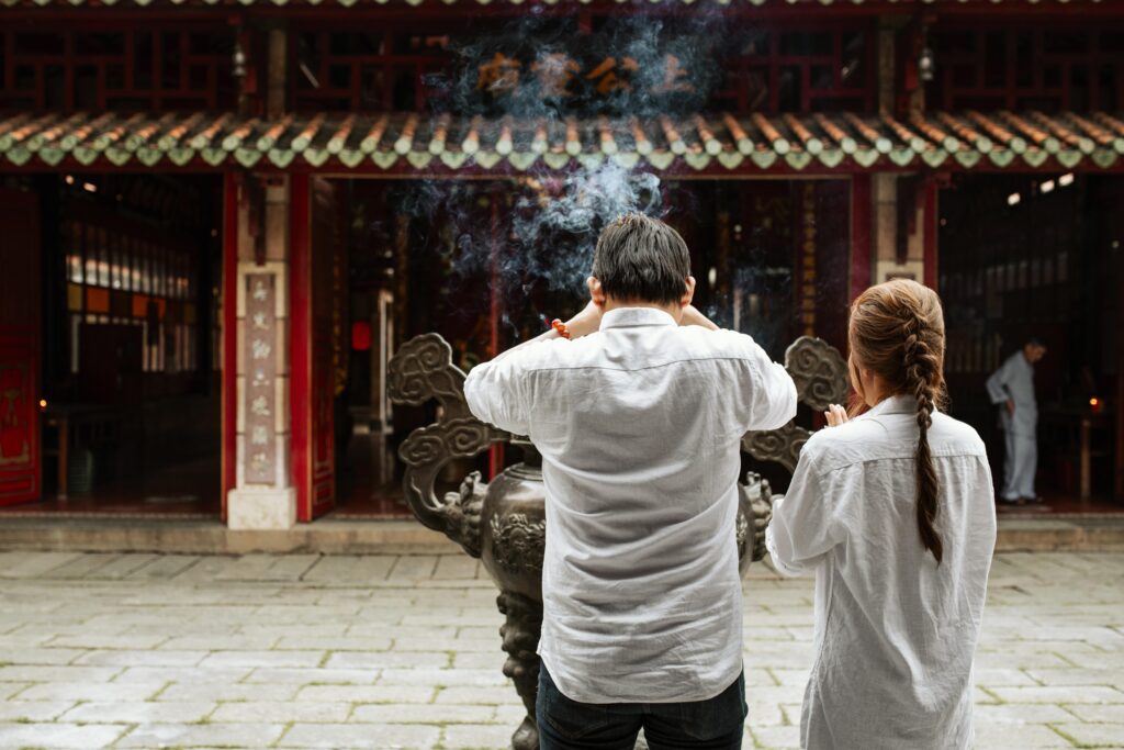 back-view-man-woman-praying-temple-with-burning-incense กินเจ